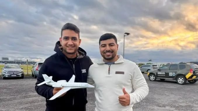 Fã emociona Juliano, de Henrique & Juliano, com miniatura do próprio jato